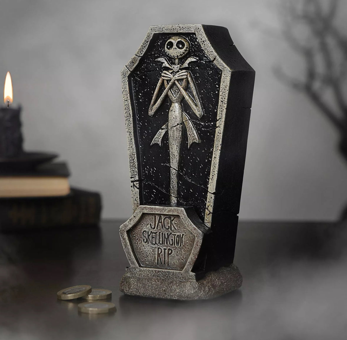 Jack Skellington doodskist-spaarpot met grafsteenontwerp, skeletfiguur en "R.I.P." tekst tegen een griezelige achtergrond.